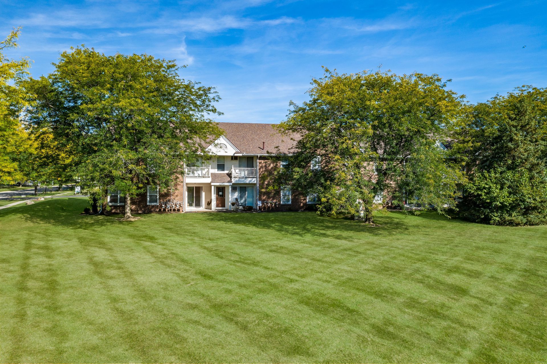 Photo of a large lawn in the back of a two-story building