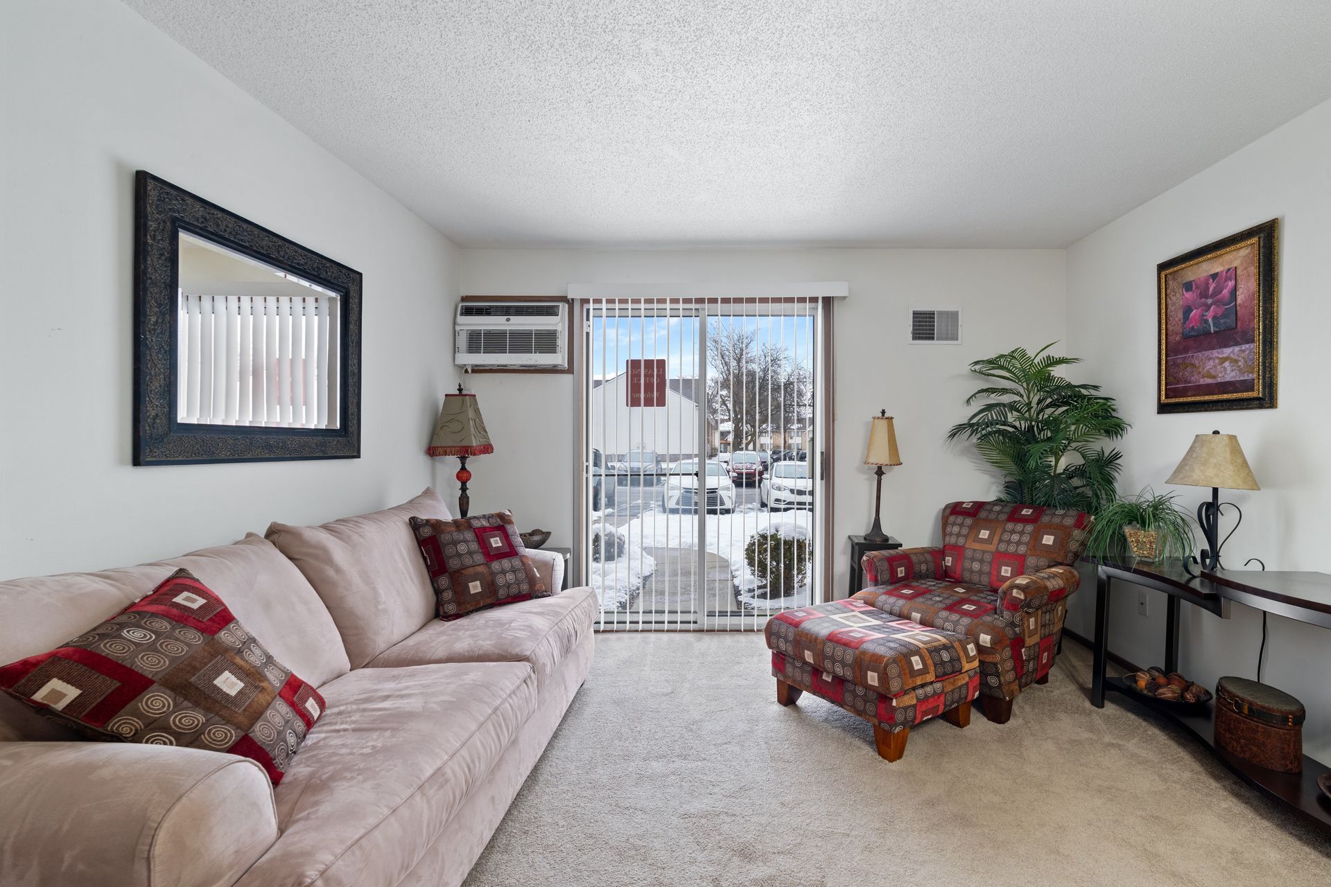 Photo of a living room with a sliding glass door on the side