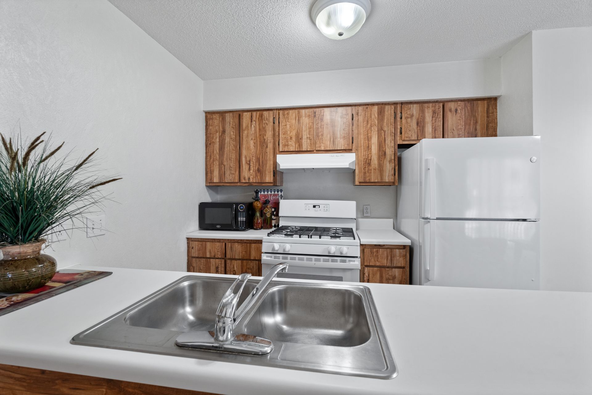 Photo of a kitchen, seen from the island area that has a sink in it