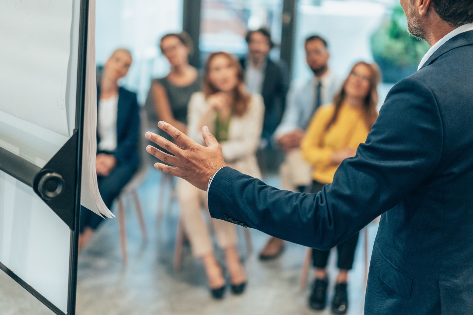 A man is giving a presentation to a group of people.