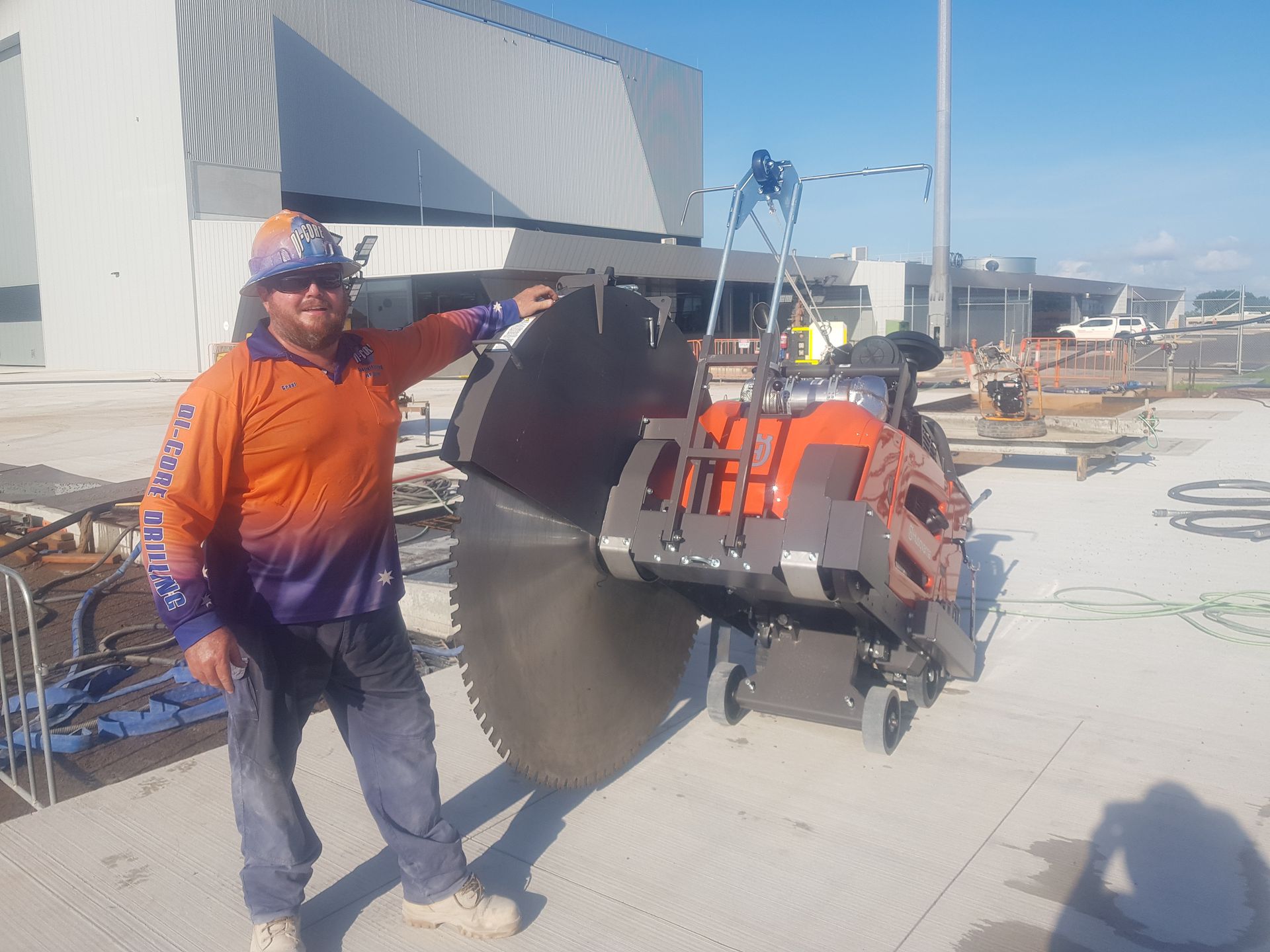 A Man Standing Next To a Bitumen Cutting Saw — Di-Core Drilling and Cutting in Darwin, NT