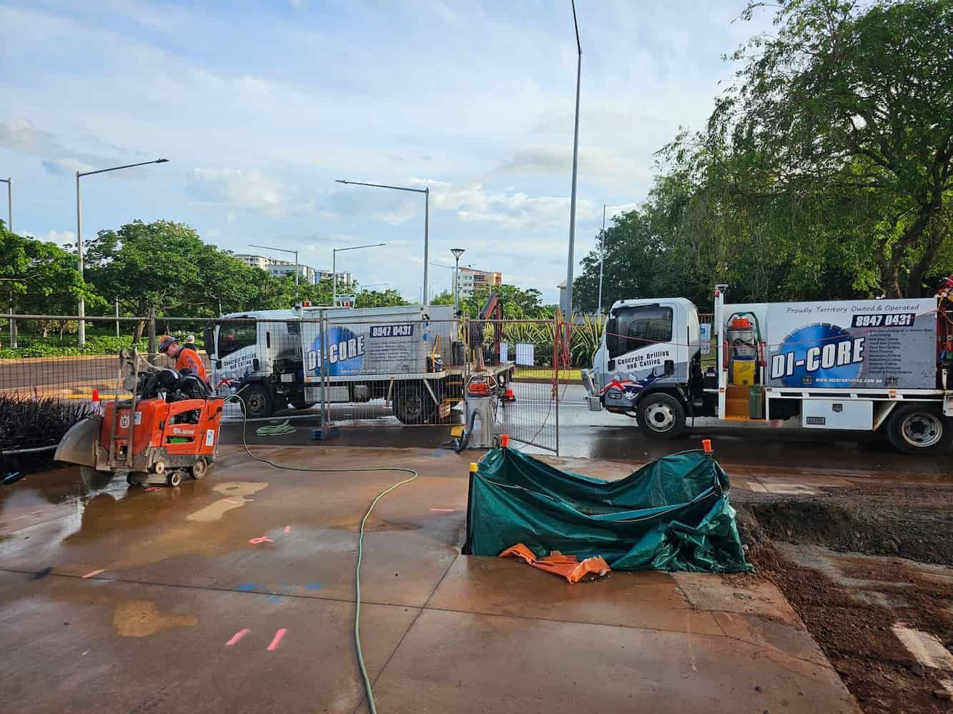 A Person is Using a Concrete Saw to Cut a Road — Di-Core Drilling and Cutting in Humpty Doo, NT
