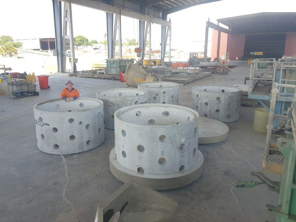 A Group of Concrete Cylinders Are Sitting on the Ground in a Warehouse — Di-Core Drilling and Cutting in Darwin, NT