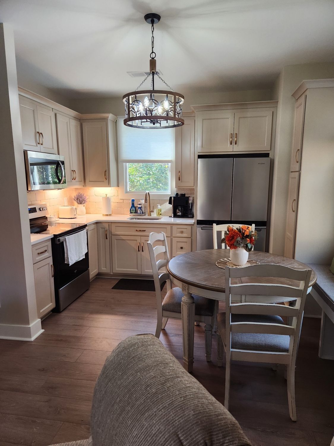 A kitchen with a table and chairs in it