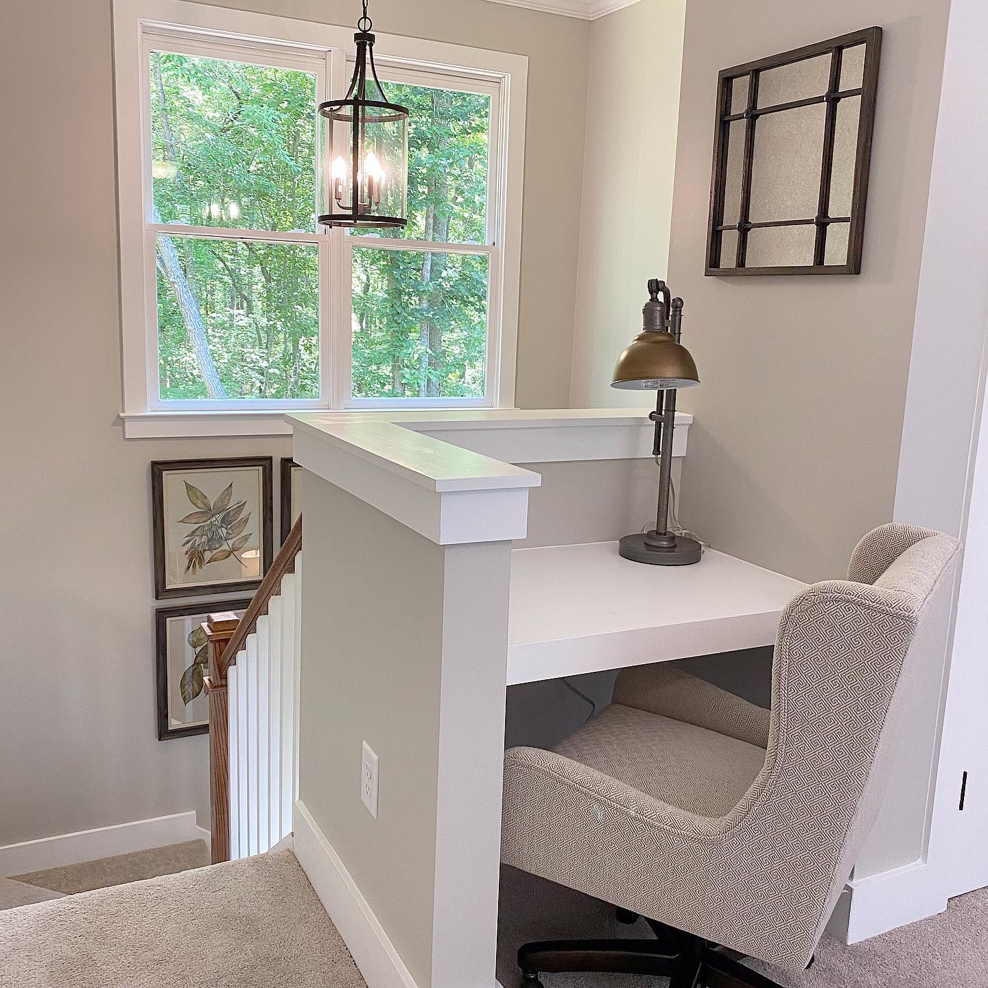 There is a desk and chair in the corner of the room.