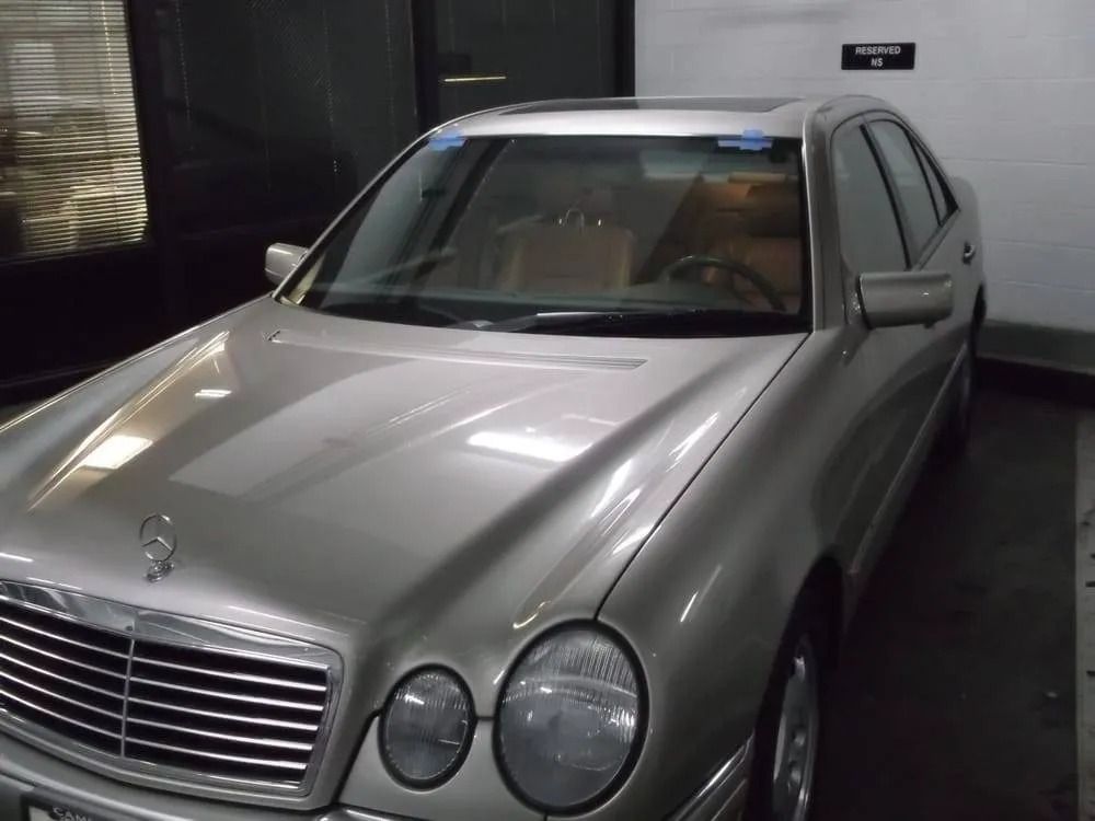 Silver Mercedes-Benz sedan parked indoors, with the hood and front visible.