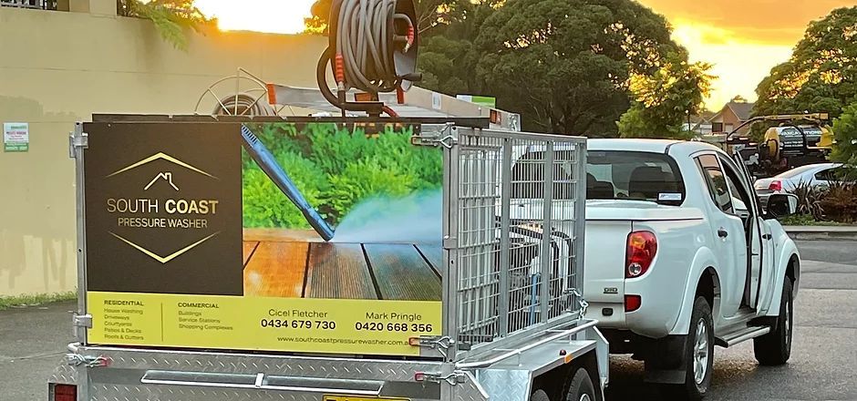 A White Truck With a Trailer Attached to It is Parked in a Parking Lot — South Coast Pressure Washer in Warilla, NSW