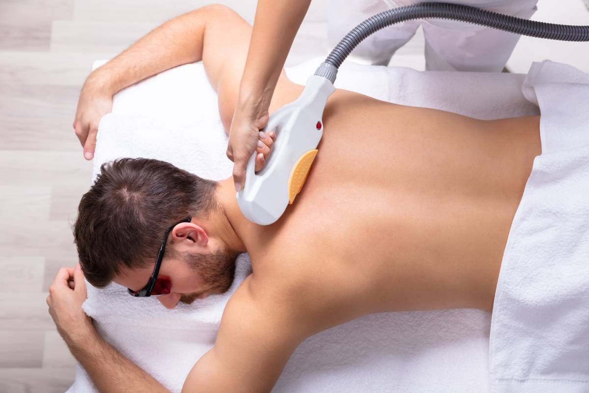 A man receiving laser hair removal treatment on his back at Lexington Tattoo Removal near Lexington, Kentucky (KY)