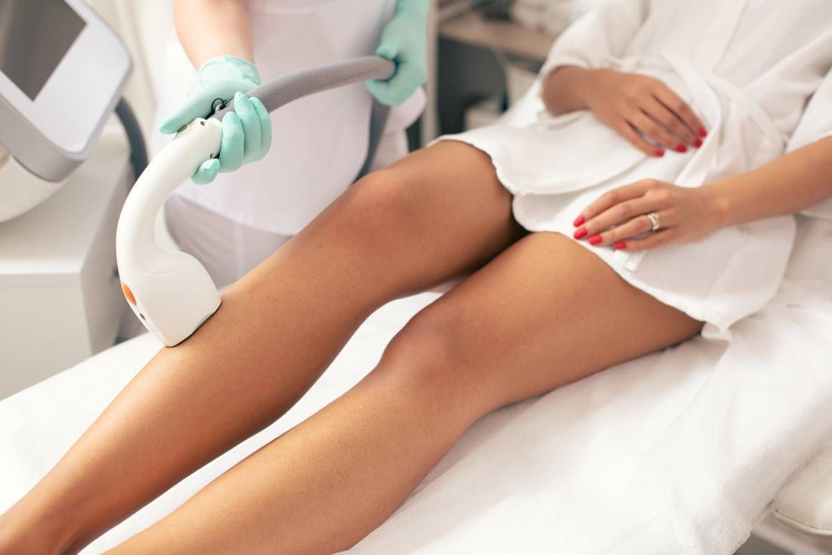 A laser hair removal specialist removes hair from a client near Lexington, Kentucky (KY)
