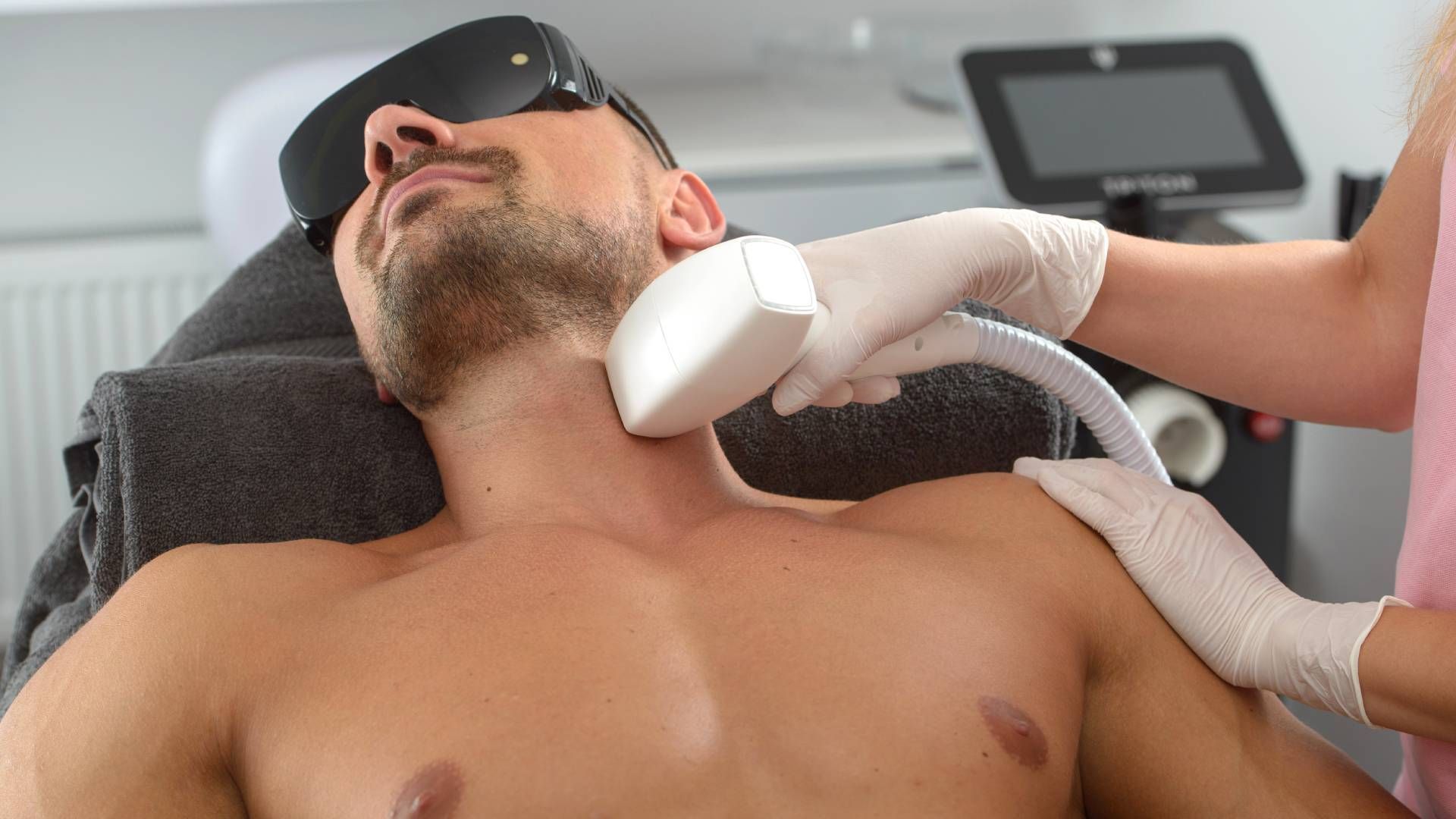 Someone receiving laser tattoo removal on their neck and face near Lexington, Kentucky (KY)