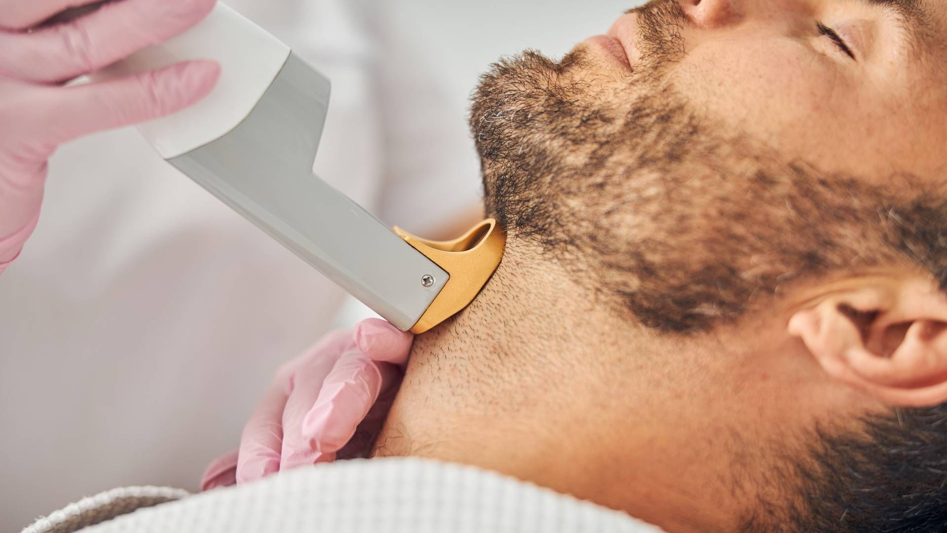 Someone receiving a laser hair removal treatment during a session at Lexington Tattoo Removal near L