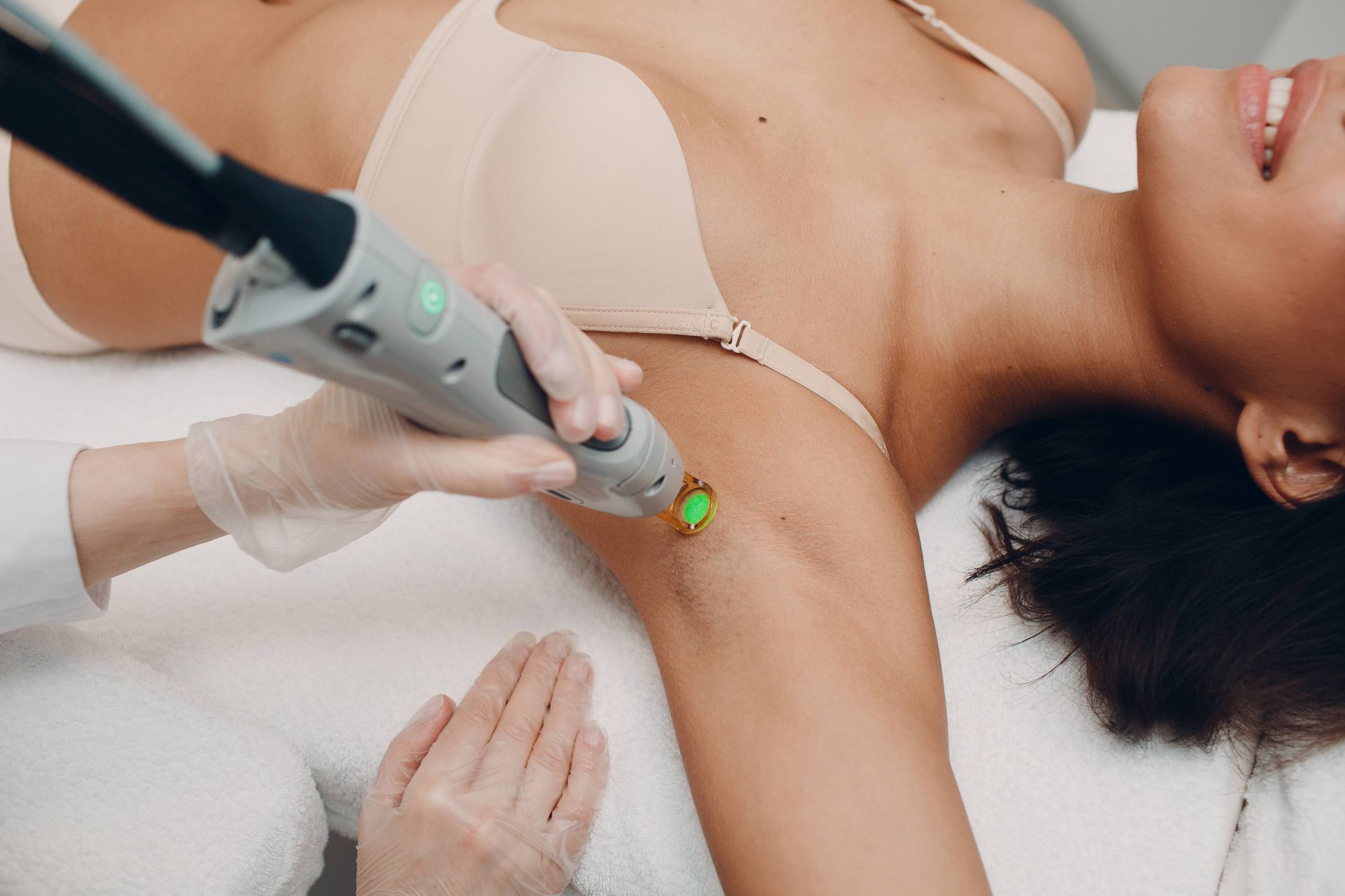 Someone receiving a laser hair removal treatment from a removal specialist