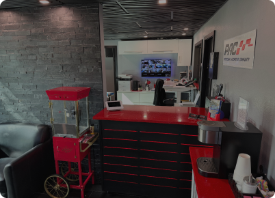 Lobby with red and black counter, popcorn machine, coffee maker, and waiting area. | Dave's Auto Repair