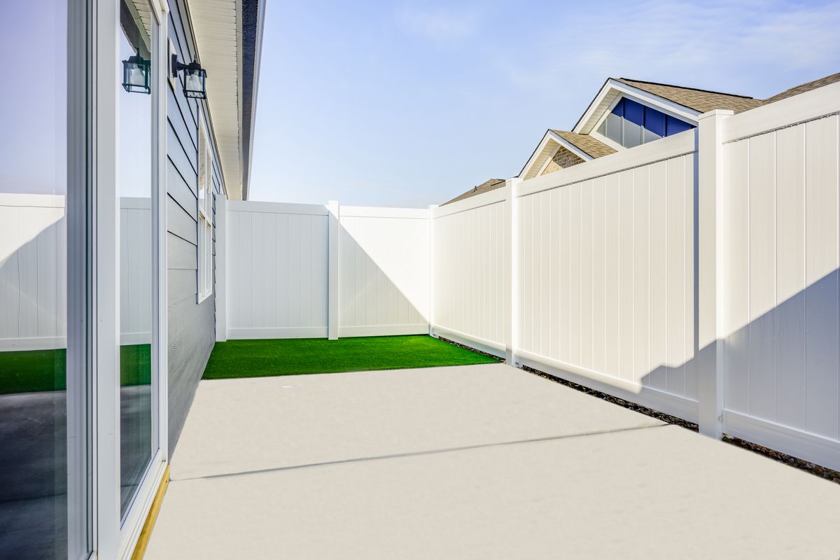 There is a white fence in the backyard of a house at Ashford Villas in Chattanooga, TN.