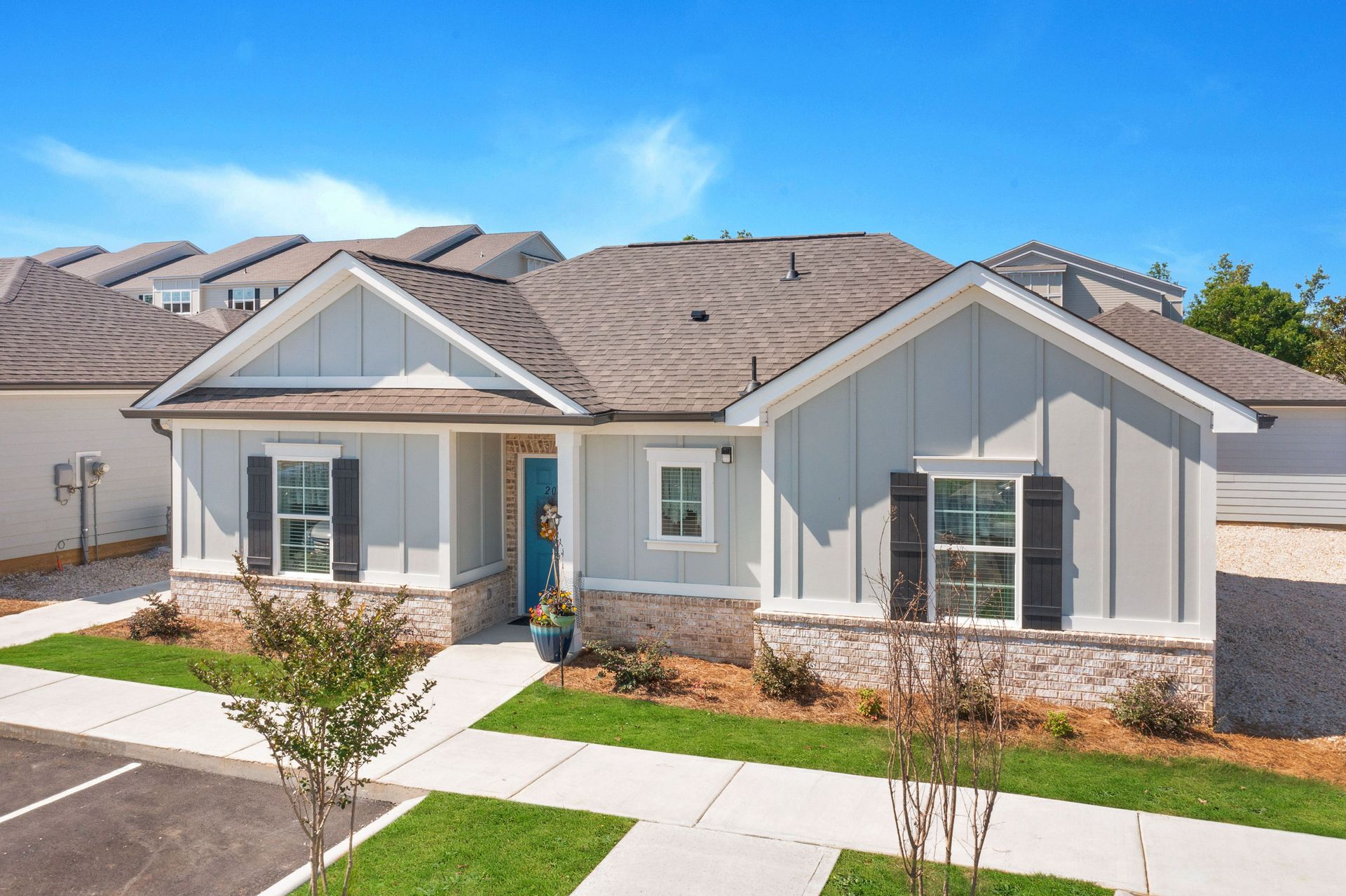 The front of a house with a blue door and shutters at Ashford Villas in Chattanooga, TN.