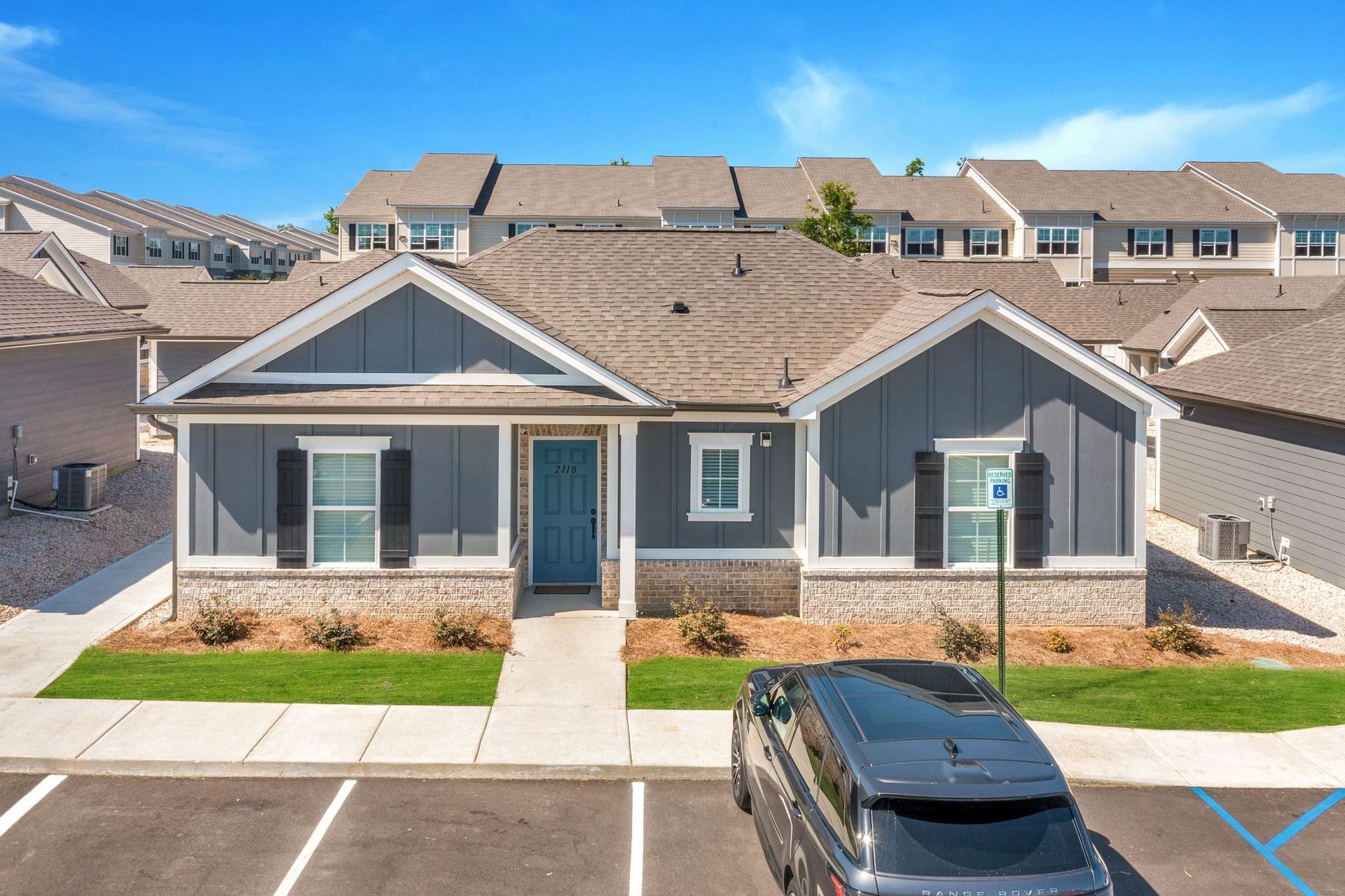An aerial view of a large apartment building surrounded by trees.