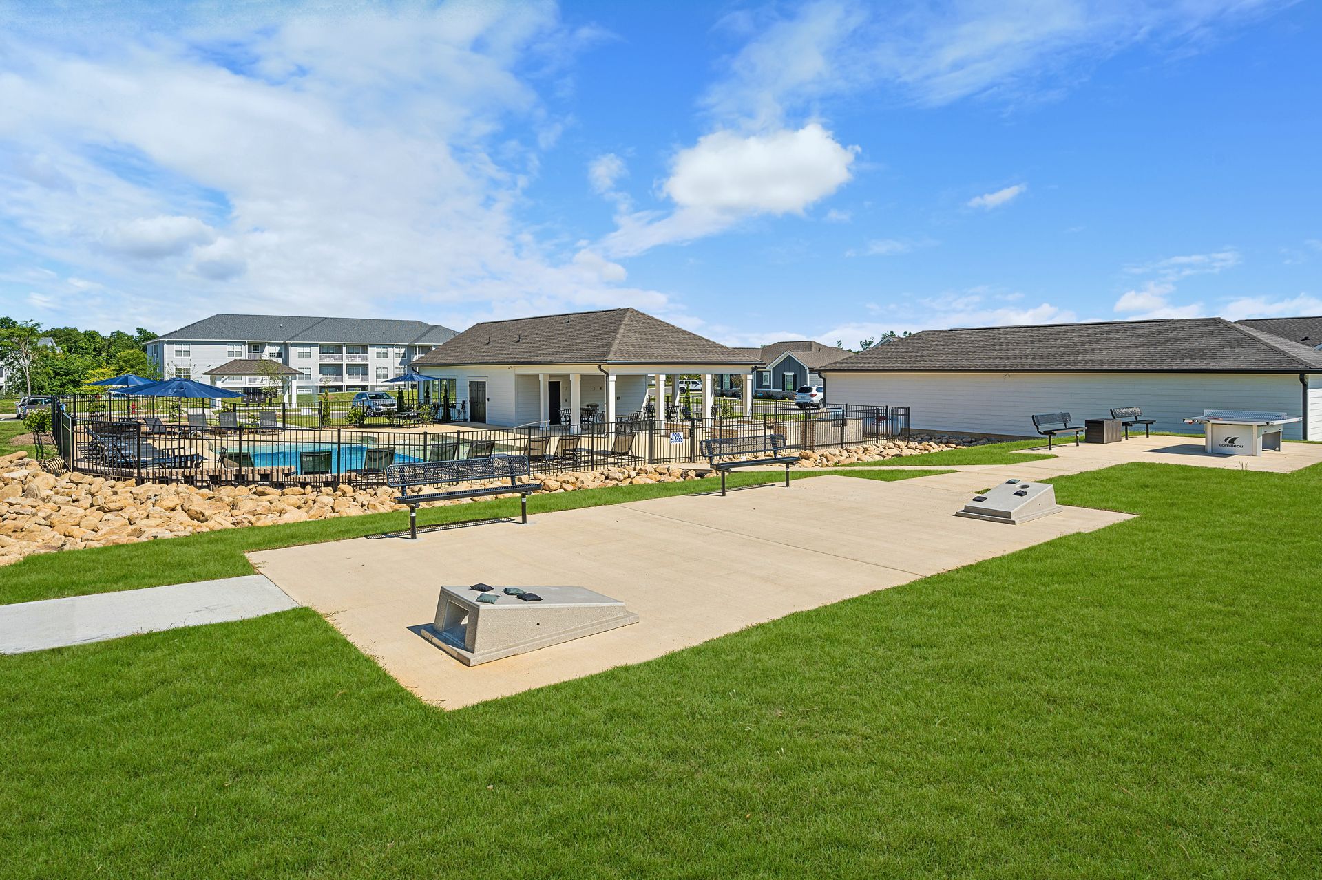 A large lawn with a house in the background and a pool in the background at Ashford Villas in Chattanooga, TN.