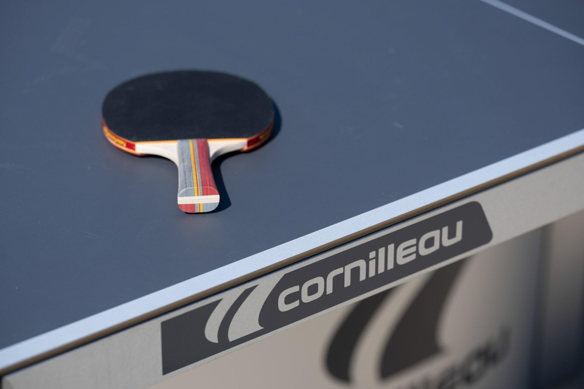A ping pong paddle is sitting on top of a cornilleau table at Ashford Villas in Chattanooga, TN.
