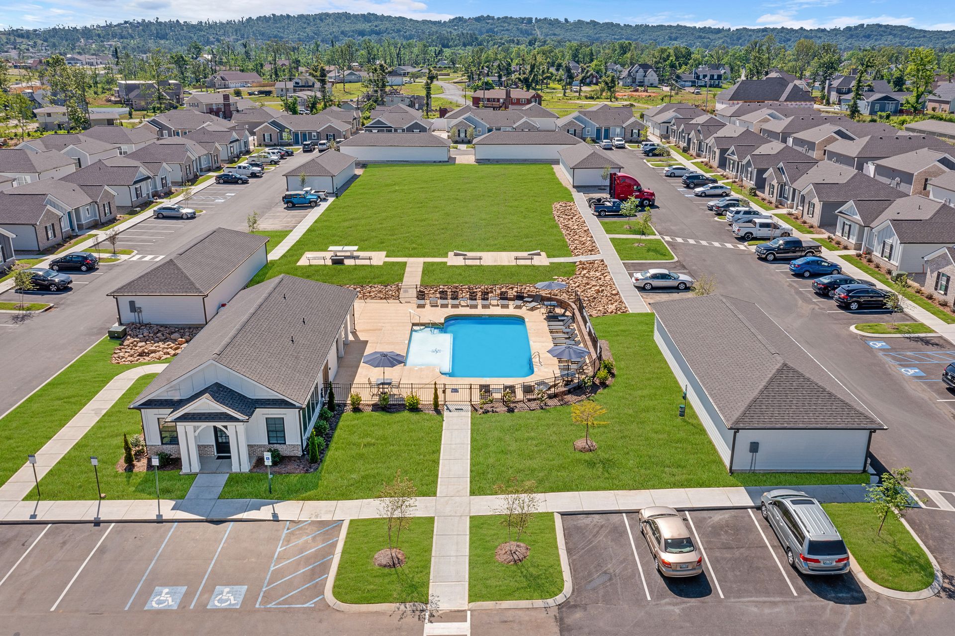 An aerial view of a residential area with a large swimming pool in the middle at Ashford Villas in Chattanooga, TN.