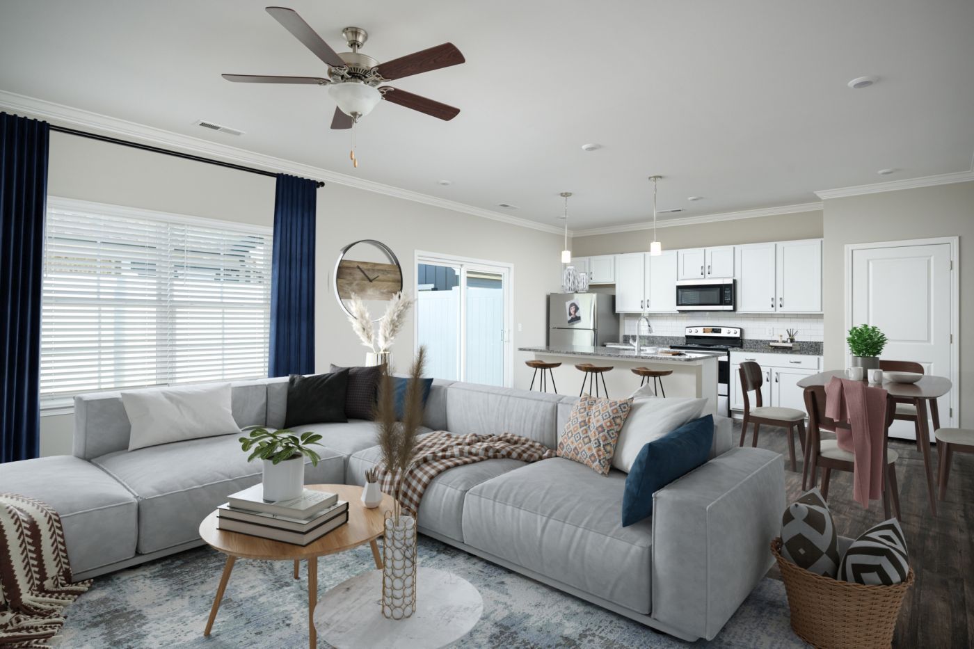 A living room with a large sectional couch and a ceiling fan at Ashford Villas in Chattanooga, TN.