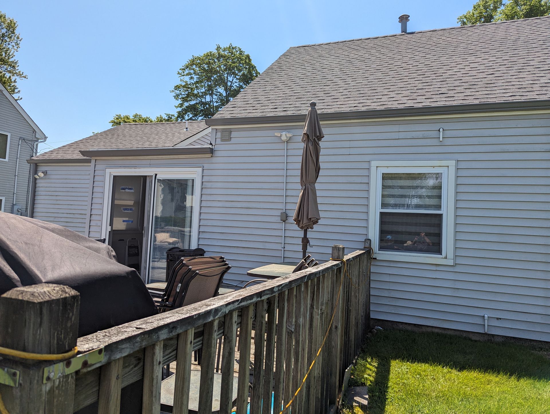 A white house with a wooden fence in front of it.