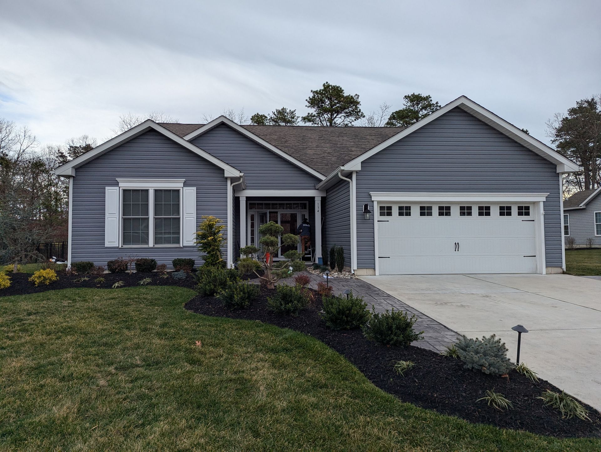 A gray house with a white garage door