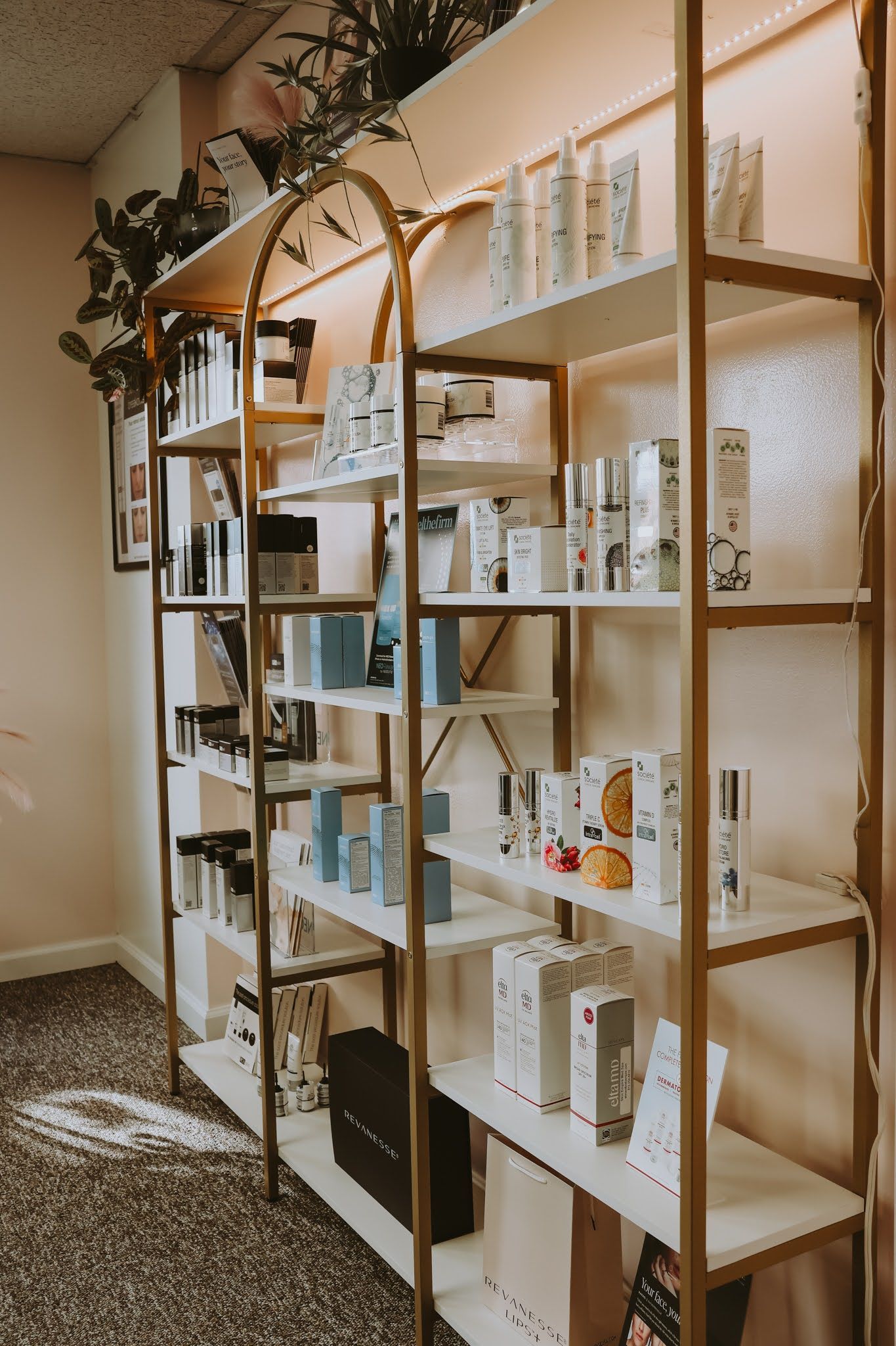 A row of shelves filled with lots of beauty products in a room.