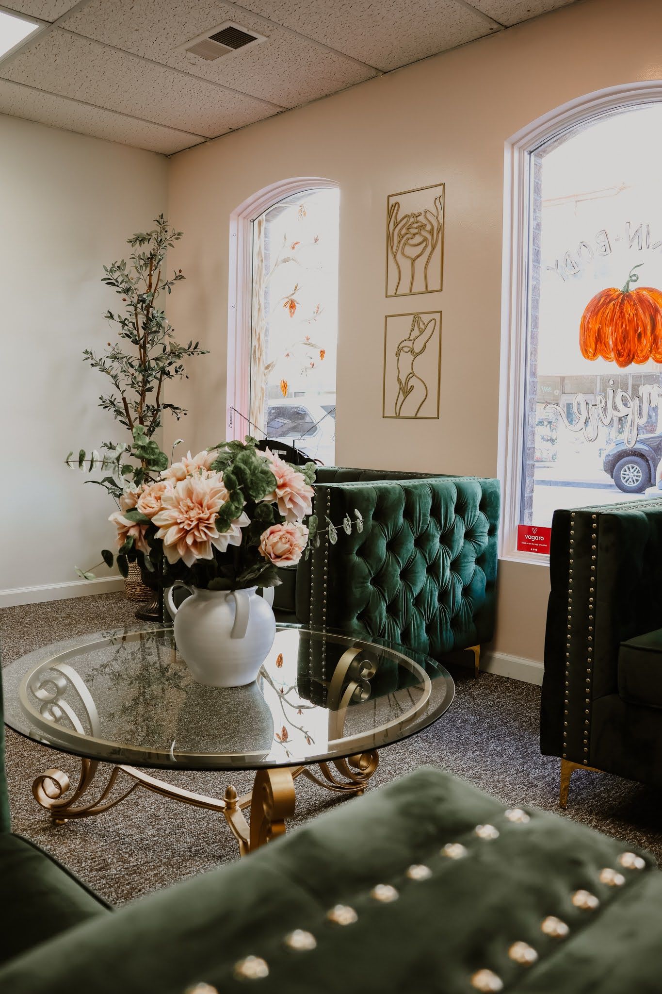 There is a vase of flowers on the table in the waiting room.