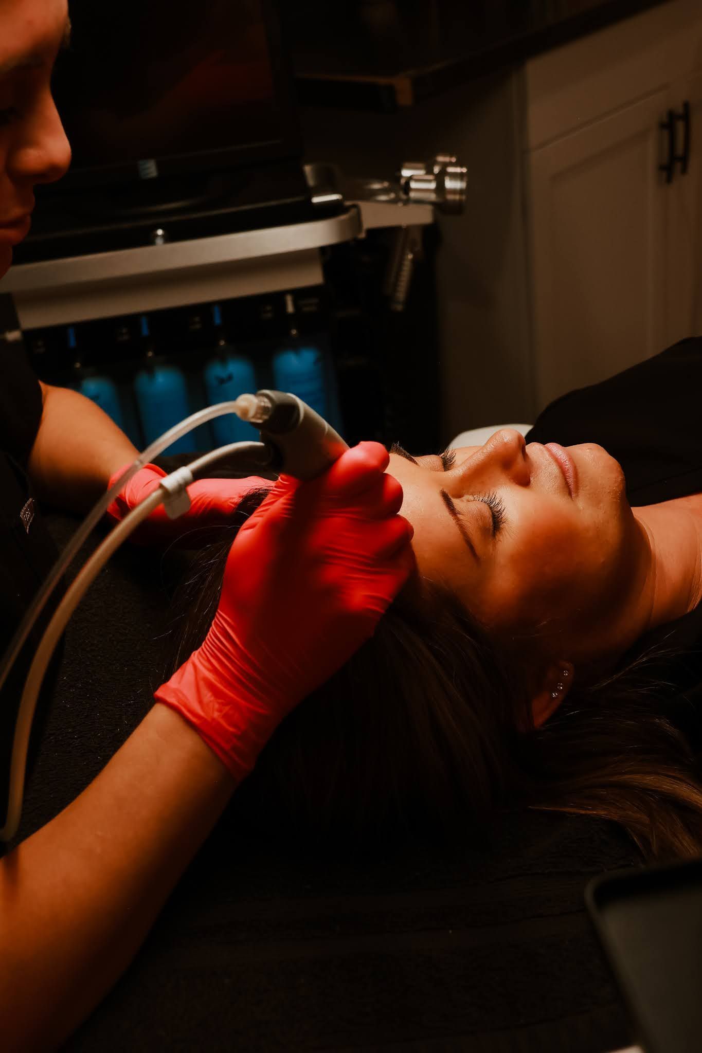 A woman is getting a facial treatment at a beauty salon.