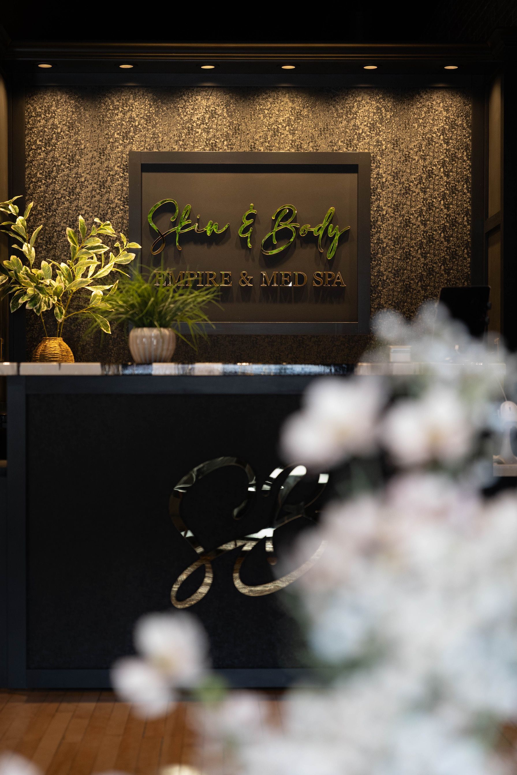 A woman is standing in front of a machine in a room.