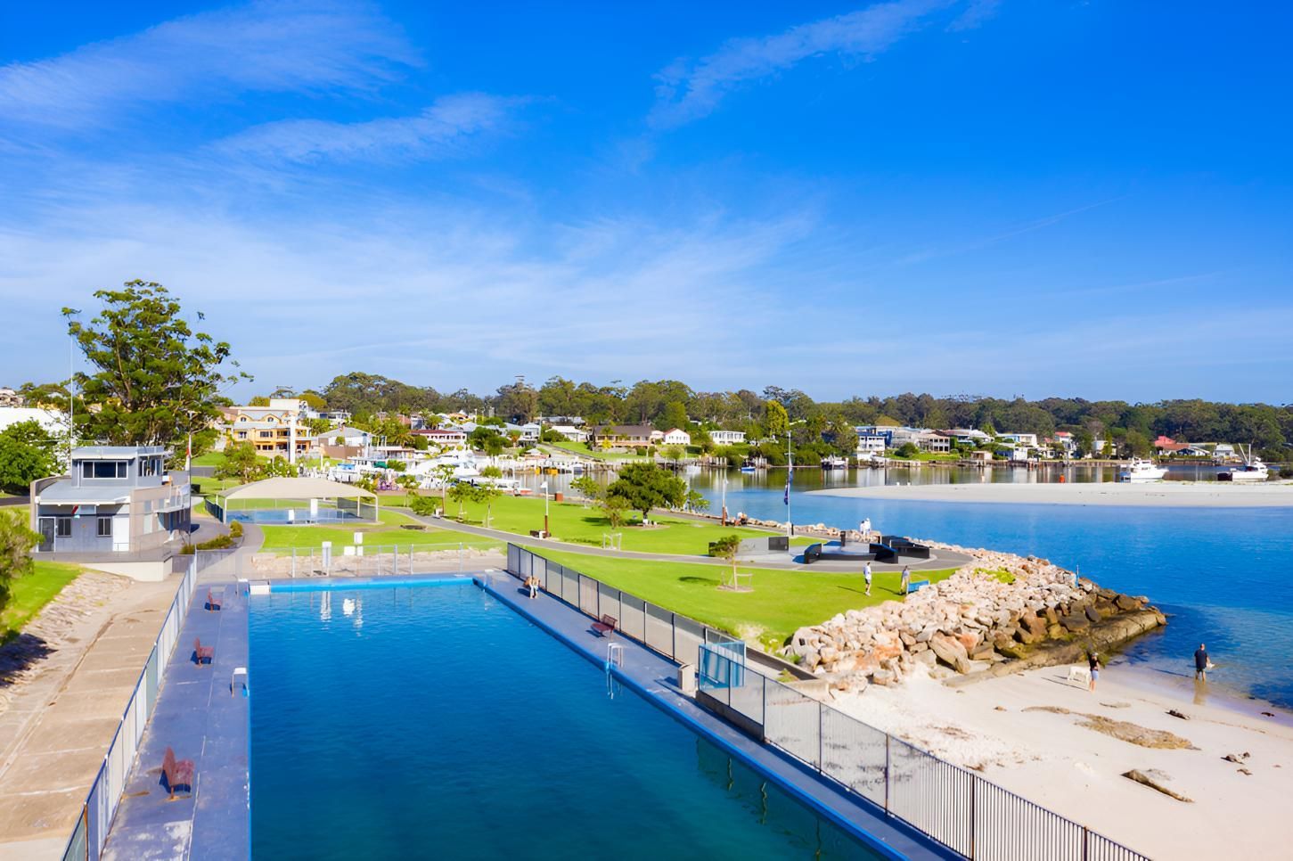 An Aerial View of a Large Swimming Pool Next to a Body of Water — NLJ Partners P/L In Wyong, NSW