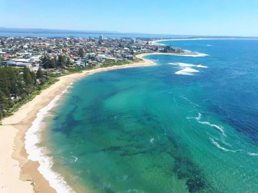 An Aerial View of a Beach and Ocean With a City in the Background — NLJ Partners P/L In Wyong, NSW