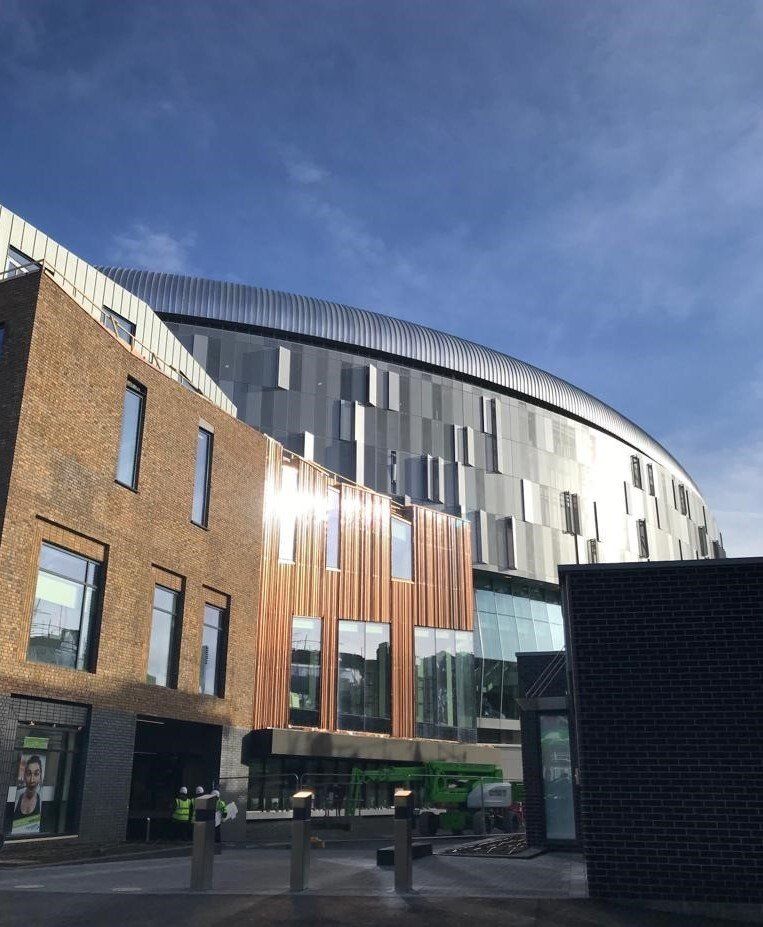 A contemporary curved building with a steel frame