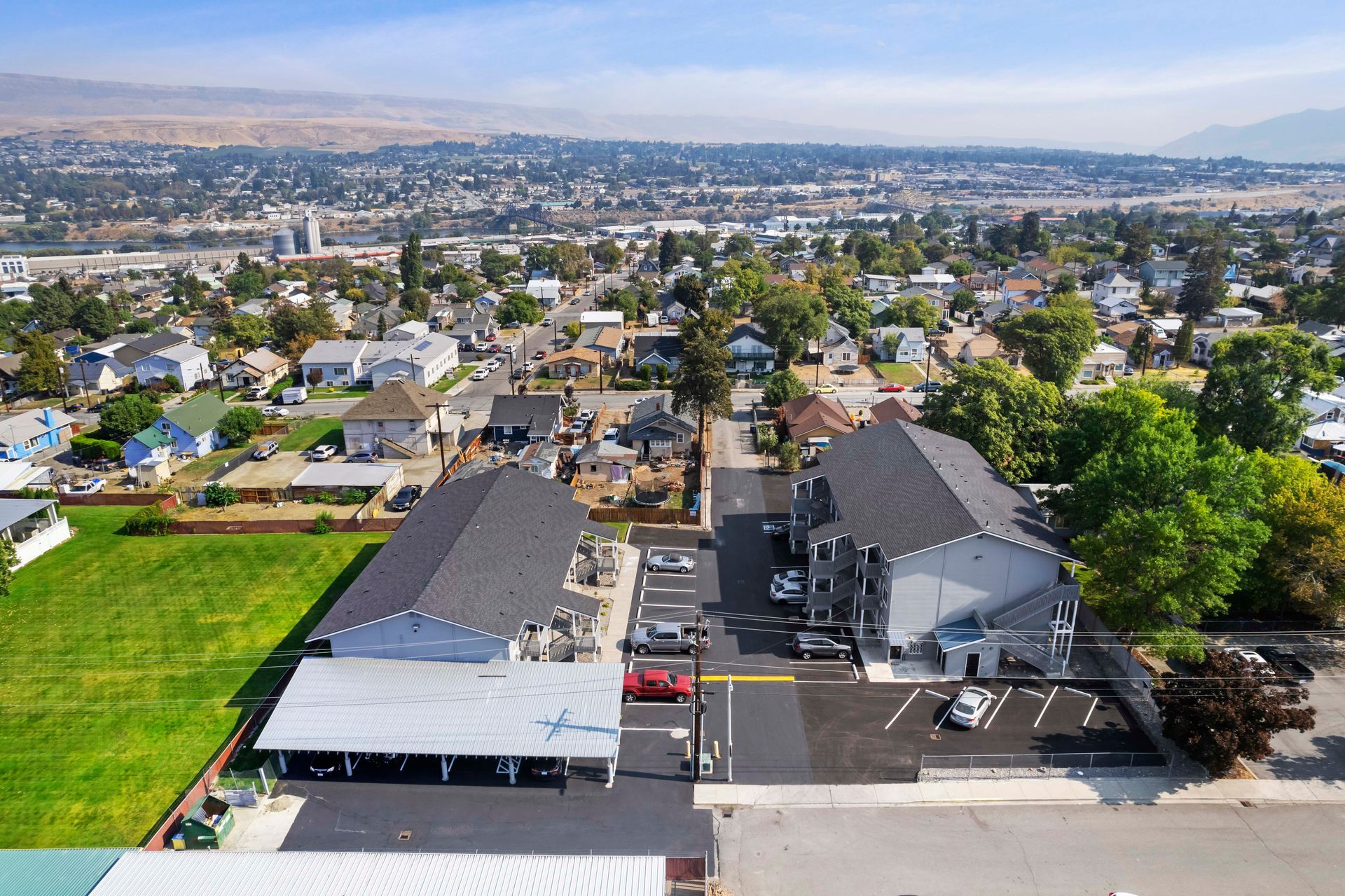 An aerial view of a residential area with a lot of houses and a parking lot.