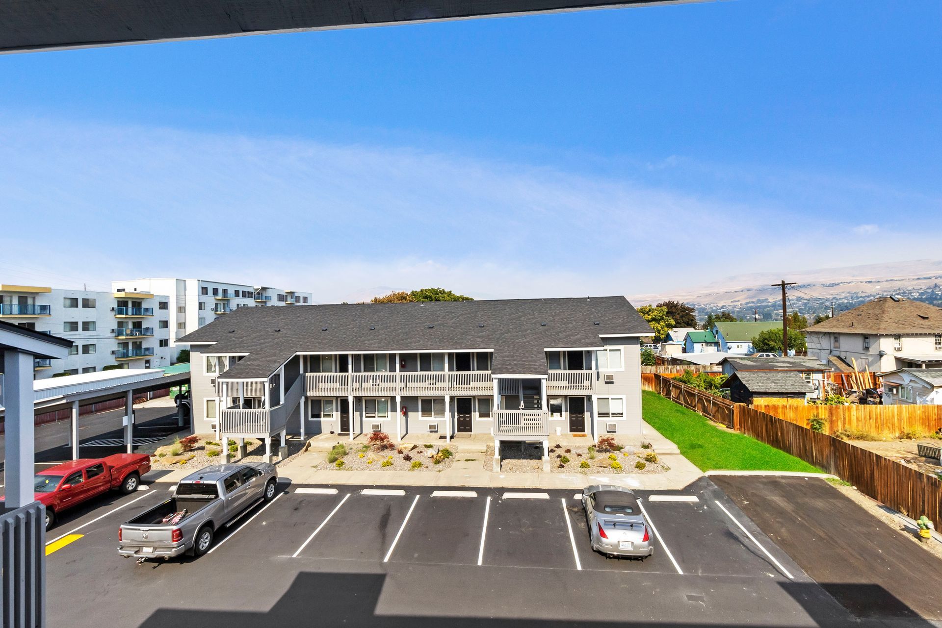 A large building with a lot of cars parked in front of it
