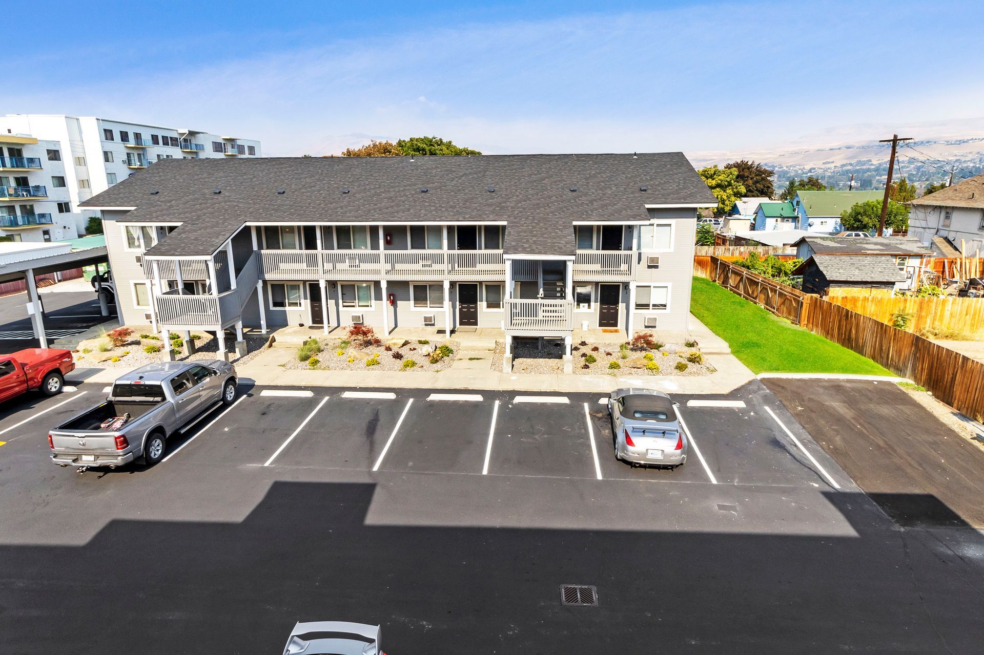 An aerial view of a building with cars parked in front of it.