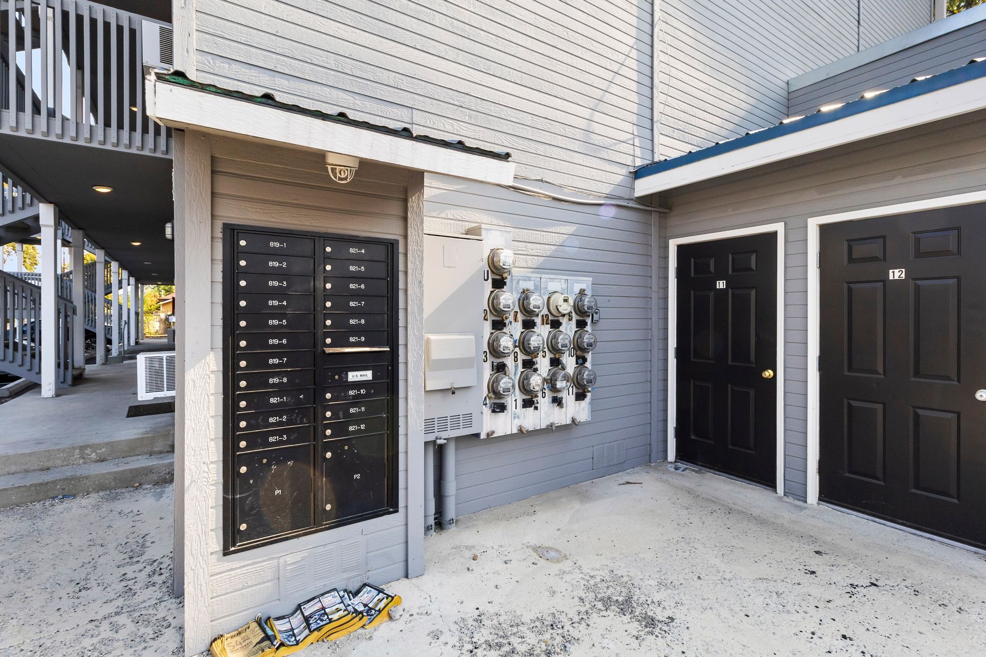 A building with a lot of mailboxes and black doors
