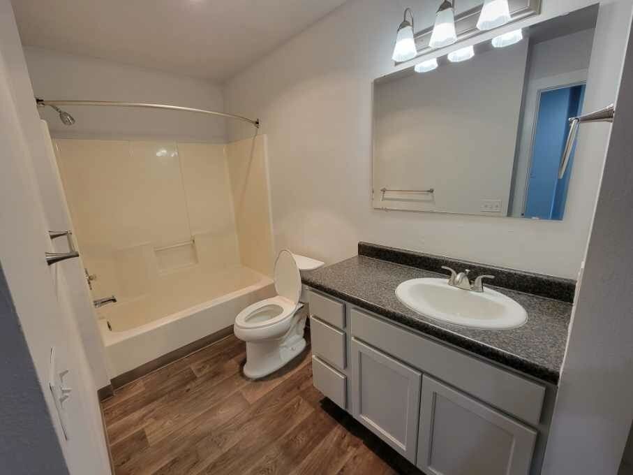 A bathroom with a toilet , sink , and bathtub.