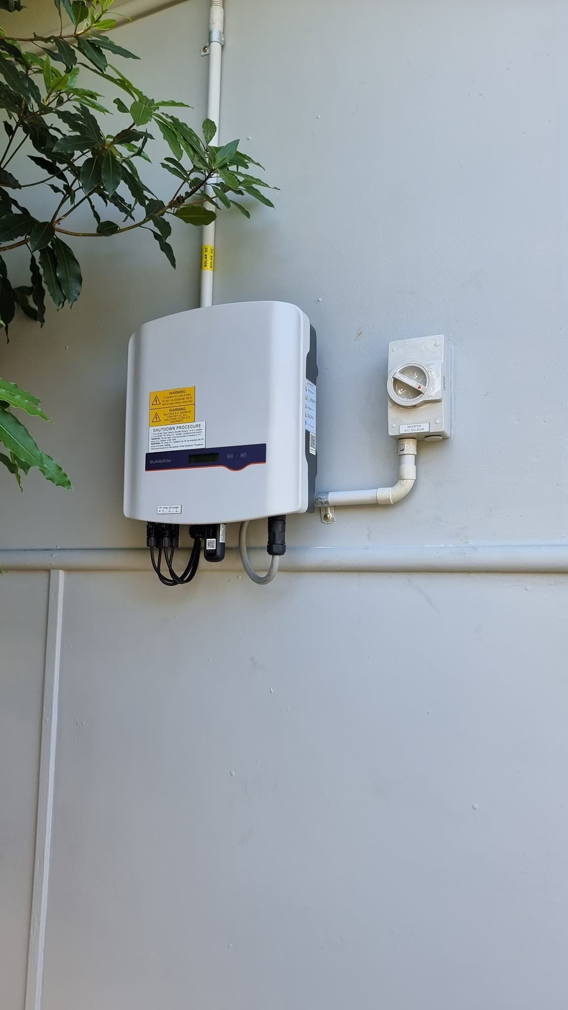 A White Box is Attached to the Side of a Building — JNQ Solar & Electrical in Thirroul, NSW