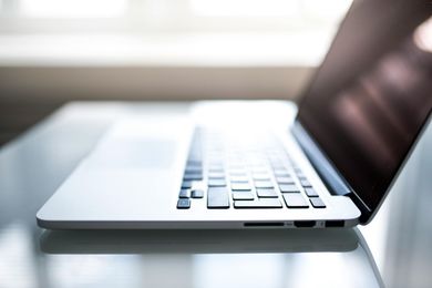 A laptop computer is open and sitting on a table