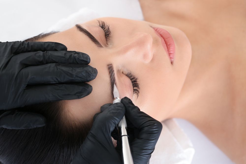 A Woman is Getting a Permanent Makeup Tattoo on Her Eyebrows — Aqua Marine Skin and Beauty in Tuncurry, NSW