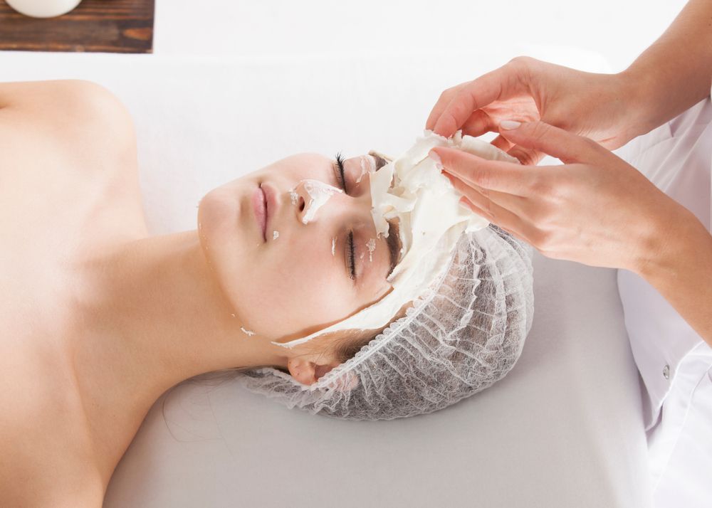 A Woman is Getting a Facial Treatment at a Spa — Aqua Marine Skin and Beauty in Tuncurry, NSW