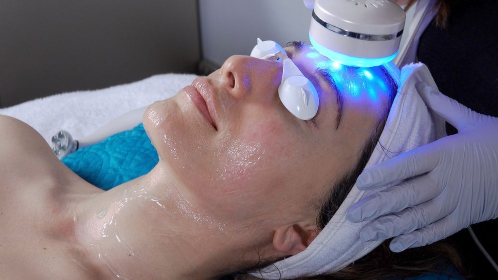 Woman Receiving Blue Light Therapy Facial Treatment at a Spa — Aqua Marine Skin and Beauty in Forster, NSW