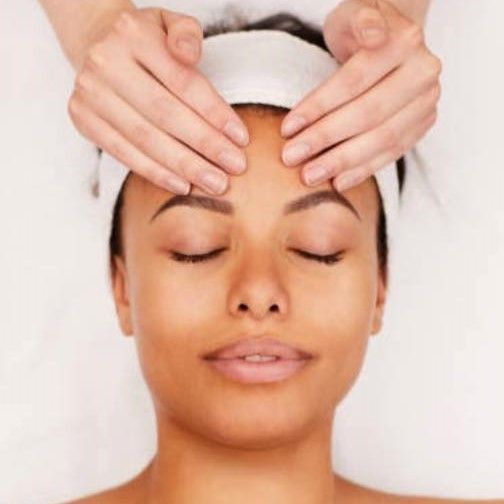 A Woman is Getting a Head Massage With Her Eyes Closed — Aqua Marine Skin and Beauty in Tuncurry, NSW