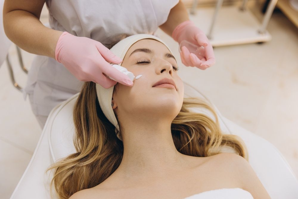 Woman Receiving Facial Treatment in a Spa — Aqua Marine Skin and Beauty in Forster, NSW