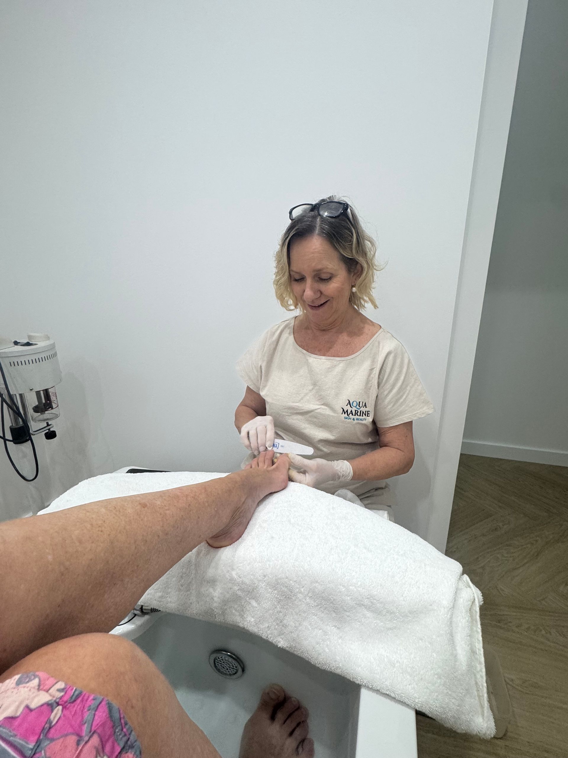 Woman With Fair Skin Holding a Tube of Ultraceuticals Sunscreen — Aqua Marine Skin and Beauty in Tuncurry, NSW