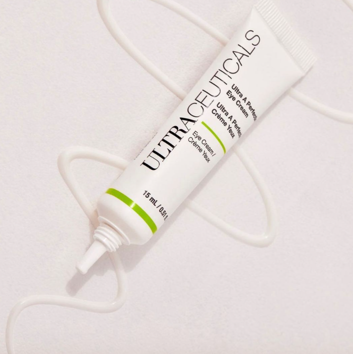 White tube of Ultraceuticals Ultra A Perfect Eye Cream on a white surface with swirls of cream. — Aqua Marine Skin and Beauty in Tuncurry, NSW