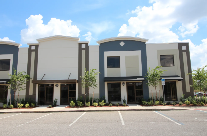 A building with a parking lot in front of it
