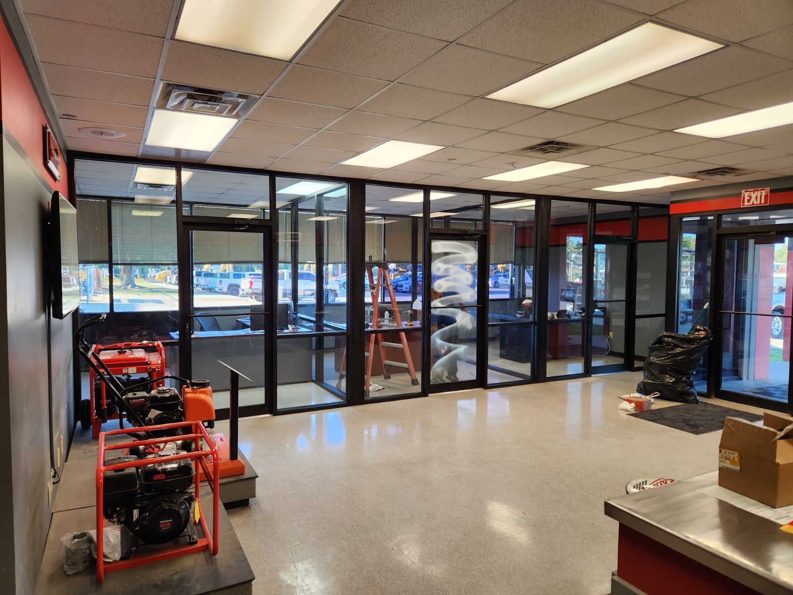 A large room with a lot of windows and a ladder.