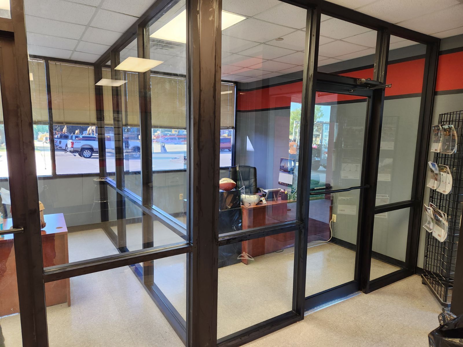 A room with a lot of windows and a desk in it